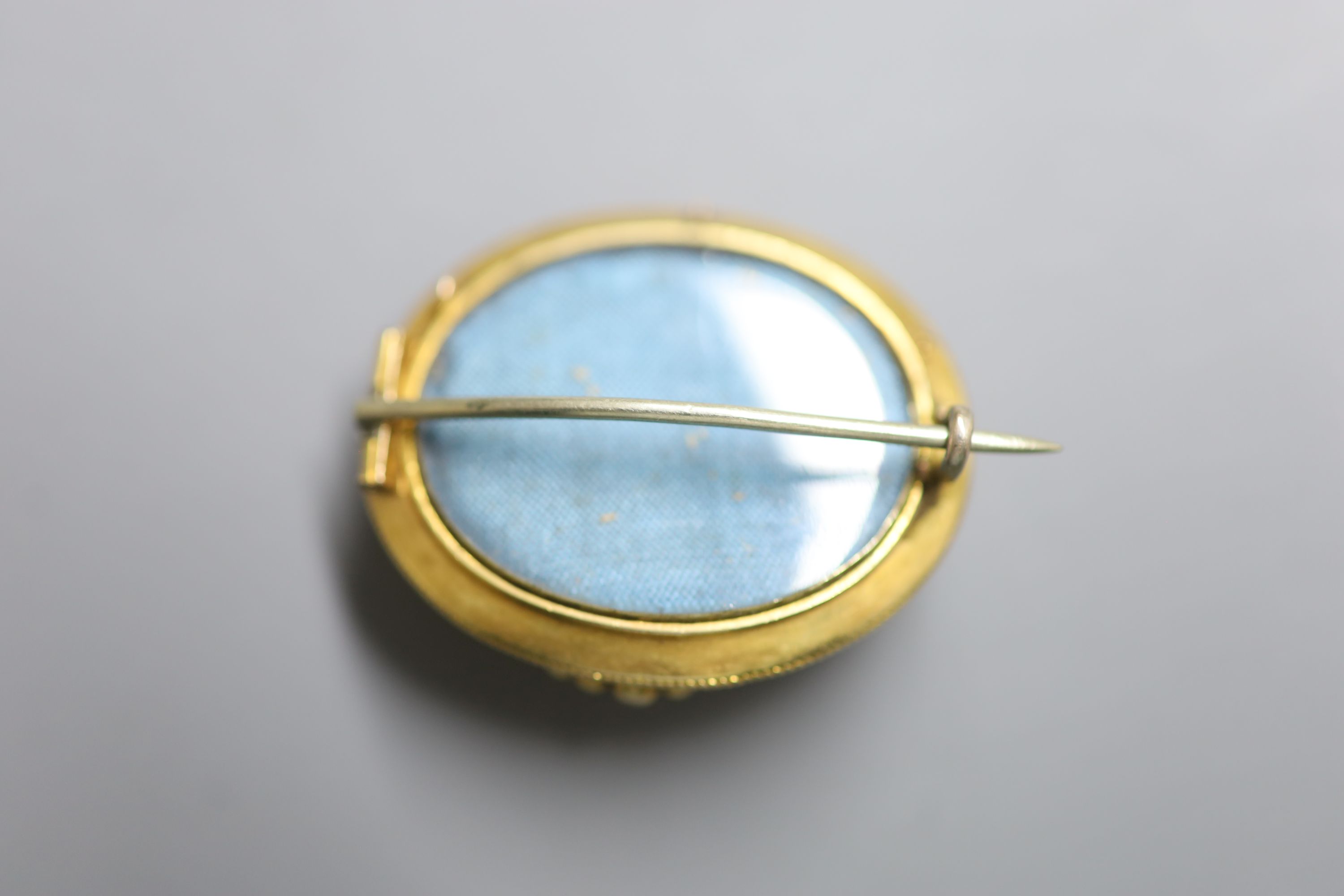 A Victorian yellow metal ,enamel and split pearl set oval mourning brooch, 32mm, gross 8.1 grams.